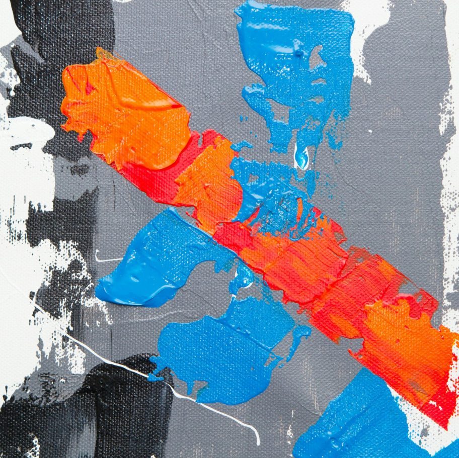 Colorful abstract art with striking red, blue, and orange brushstrokes on canvas.